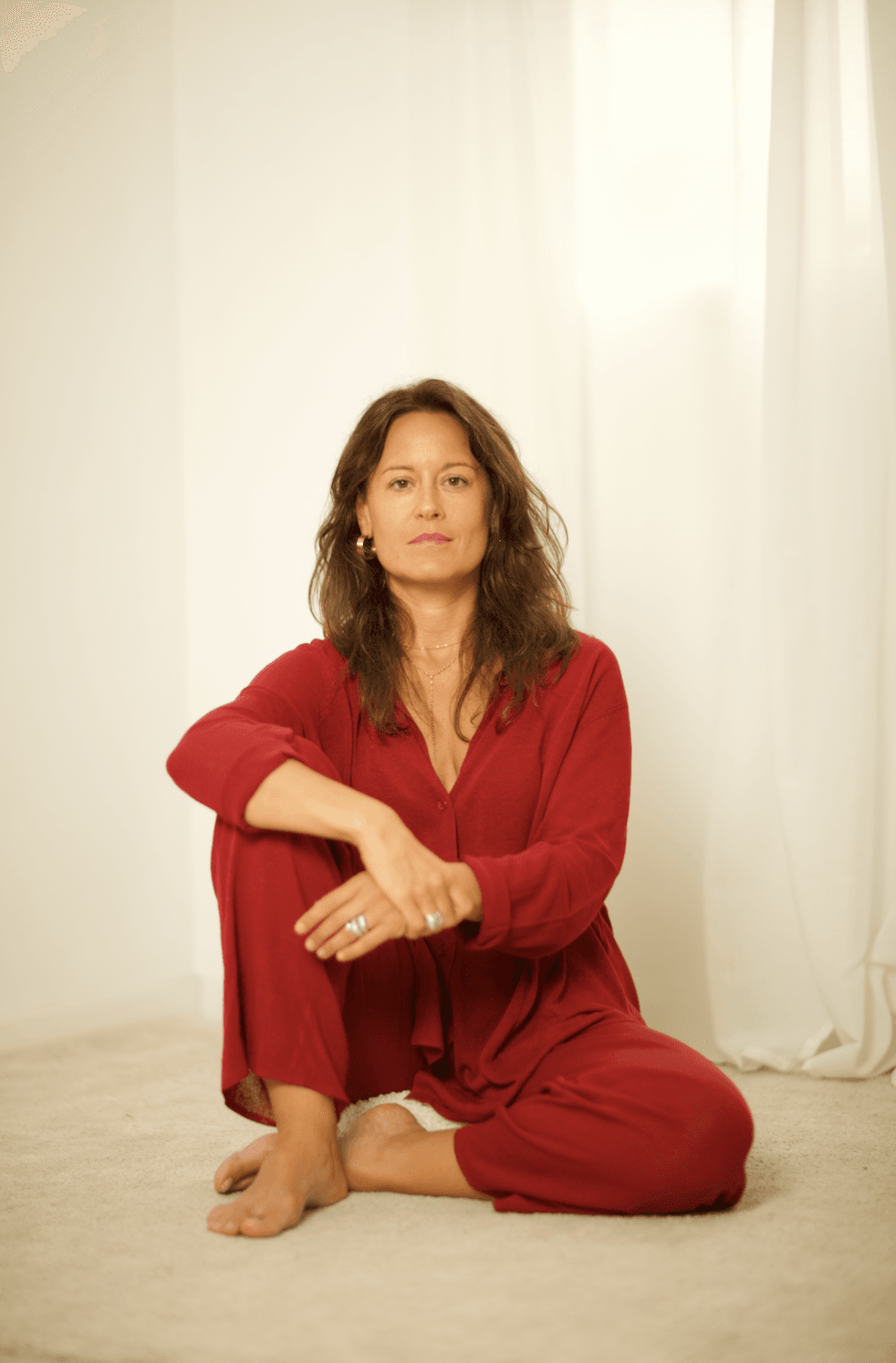 Núria seated quietly in soft daylight, a reflective moment