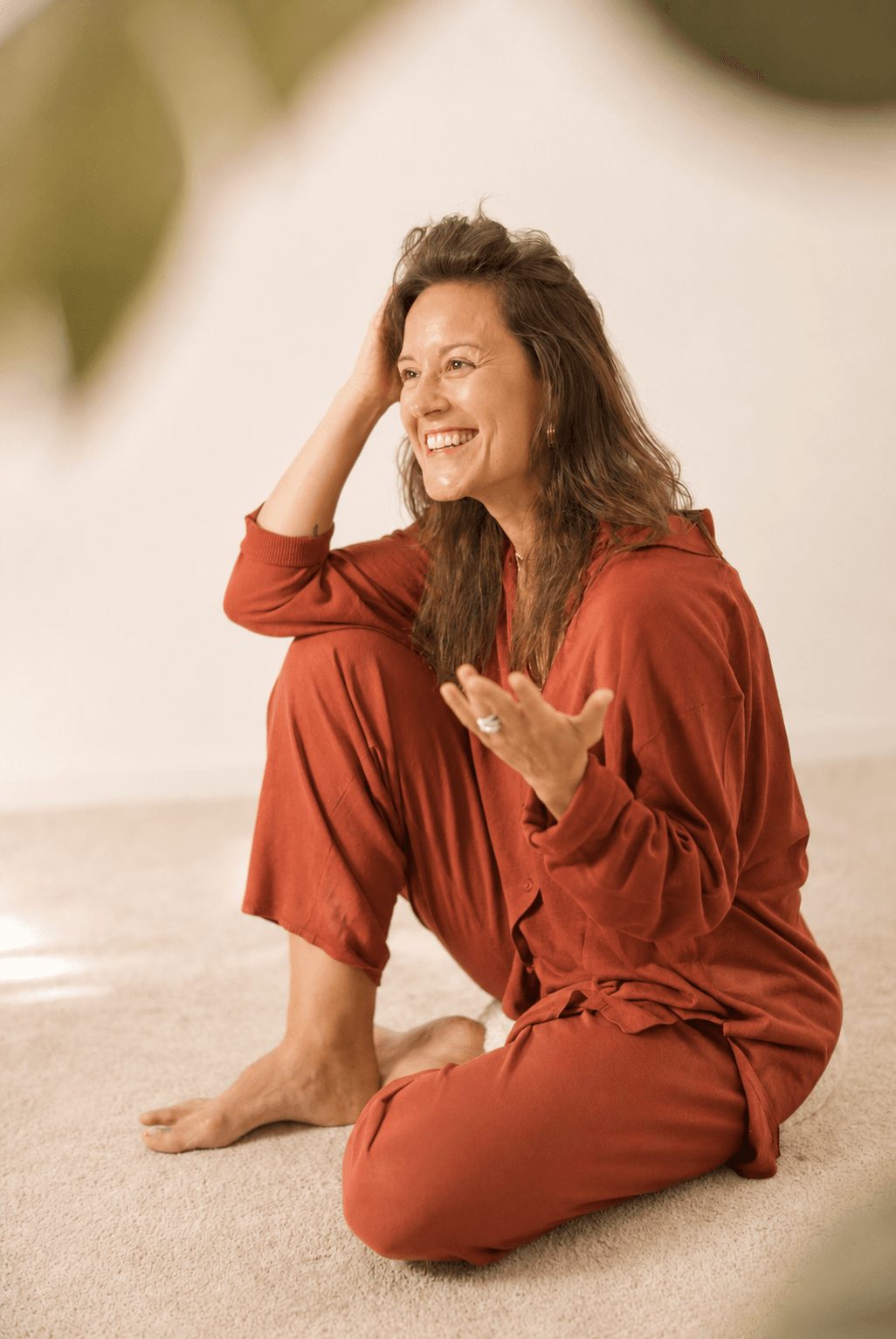 Núria in a red shirt, laughing during a session